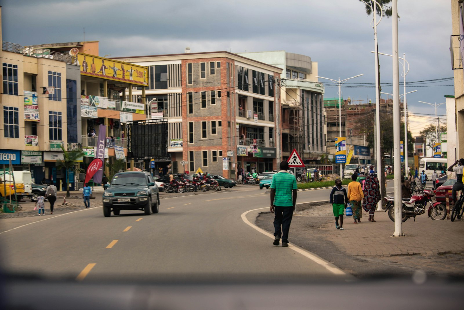People walking on a Kigali street lined with buildings, Rwanda